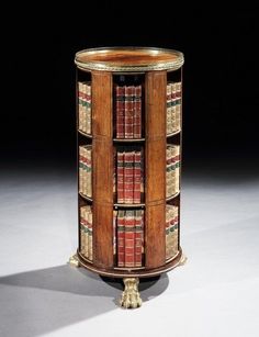 a tall wooden book shelf with many books on it's sides and three shelves