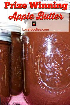 three jars filled with brown liquid sitting on top of a pink table cloth and text overlay that reads, prize winning apple butter