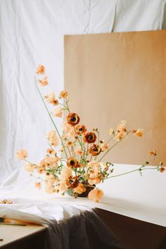 a vase filled with flowers sitting on top of a table