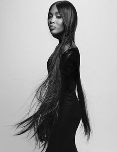 a black and white photo of a woman with long hair