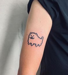 a person with a pixel art tattoo on their arm