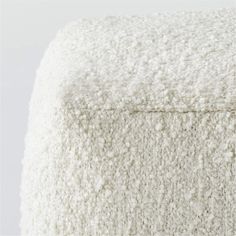 a close up of a white blanket with no sheets or pillows on the bottom half