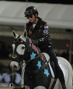 a man riding on the back of a white horse