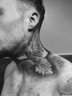 a man with a bird tattoo on his chest