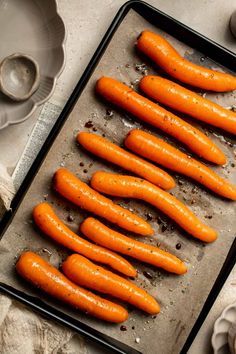 there are many carrots that have been cooked on the baking sheet and ready to go into the oven