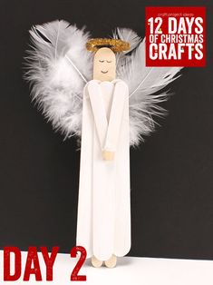 a paper angel with white feathers on it's head and the text 12 days of christmas crafts day 2