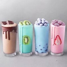 four different types of milkshakes with toppings