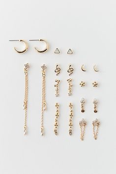 Set of 10 pairs of earrings - wear them as pairs or mix & match them for a one-of-a-kind earring stack look. Includes hoops and post earrings. Features Celestial rhinestone post & hoop earrings set Earrings set with rhinestone embellishments Set of ten pairs Includes studs, chains, dangle and hoop earrings Gold metal Post backings Content + Care Set of 10 pairs Mixed metal, glass Avoid contact with water Imported | Celestial Rhinestone Post & Hoop Earring Set in Gold, Women's at Urban Outfitters Hoop Earring Set, Earring Stack, Metal Post, Hoop Earrings Gold, Hoop Earring Sets, Mixed Metals, Women Accessories Jewelry, Mix Match, Post Earrings