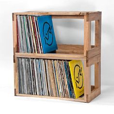 a wooden shelf filled with lots of records