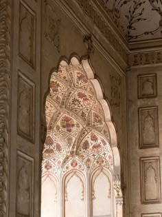 an intricately decorated wall in the middle of a building with ornate carvings on it