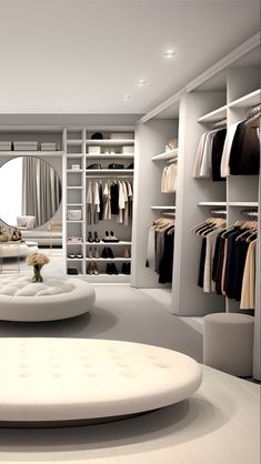 a white room with clothes on shelves and a round ottoman in the middle, surrounded by other closets