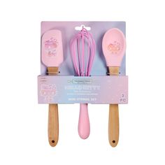 three pink kitchen utensils with hello kitty designs on them in a cardboard package