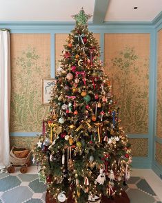 a decorated christmas tree in the corner of a room