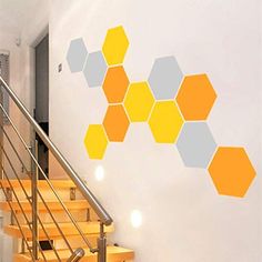 the stairs are lined with yellow and gray hexagonal tiles on the wall above them