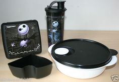 a black and white container sitting next to a cup