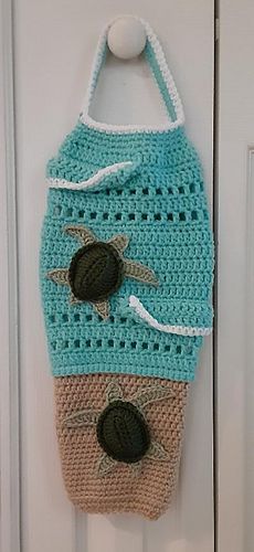 a crocheted bag hanging on the front door