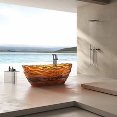 a large glass bowl shaped sink sitting on top of a counter next to a window