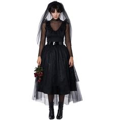 a woman wearing a black dress and veil with flowers in her hand, standing against a white background