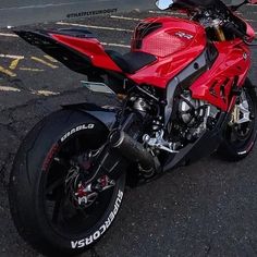 a red motorcycle parked in a parking lot