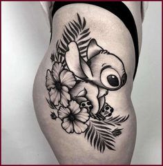 a woman's thigh with an image of a koala and flowers on it