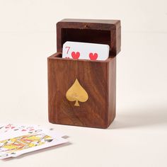 a wooden box with playing cards in it