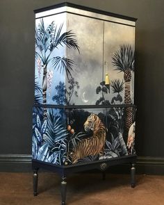 a tiger painted on the side of a cabinet with palm trees and moon in the background