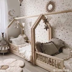 a room with two beds and pillows on the floor, one is made out of wood