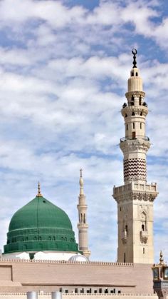 a tall white building with a green dome