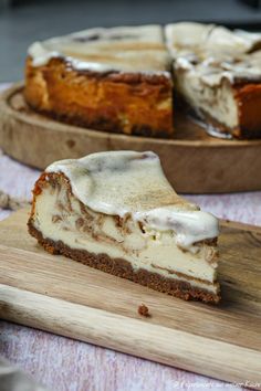 a piece of cheesecake sitting on top of a wooden cutting board