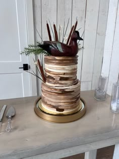 there is a cake that has birds on it and branches in the top tiers