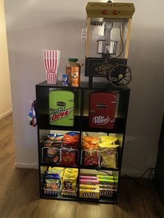 a shelf filled with food and snacks on top of a hard wood floor