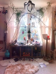 a living room filled with lots of furniture and plants on the window sill next to a fire place