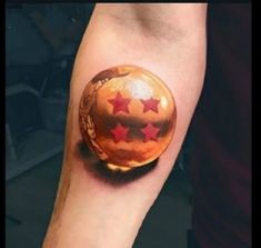 a person with a tattoo on their arm has a ball and stars painted on it