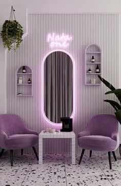 two purple chairs in front of a mirror with neon lights on the wall above it