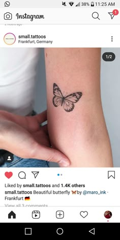 a woman's arm with a small butterfly tattoo on it