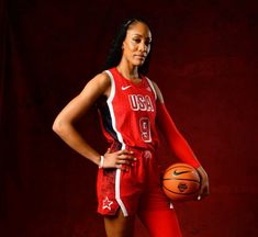 a female basketball player is posing for a photo