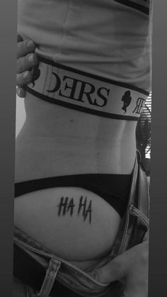 a woman's stomach with her name tattooed on the lower part of her belly