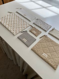 there are many different patterns on the table cloths that have been folded up together