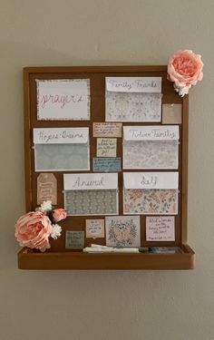 a wooden board with many different types of cards and flowers on it's side