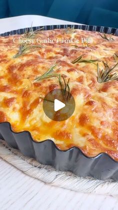 a baked dish with cheese and rosemary on top