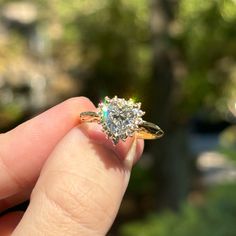 a woman's hand holding an engagement ring