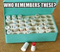 a blue box filled with rolls of toilet paper next to a tube of toothpaste