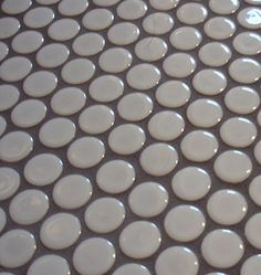 a close up view of white circles on a tile floor