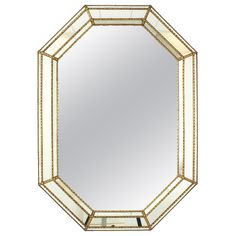 an octagonal mirror with gold trimmings on the edges and a white border around it