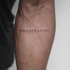 a person with a tattoo on their leg that says twenty sevenen in black ink