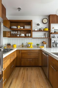 the kitchen is clean and ready for us to use it's counters are made of wood