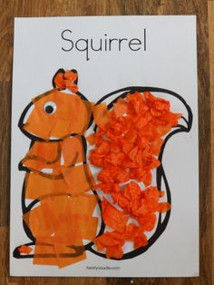 an orange squirrel made out of tissue paper on top of a piece of paper with the word squirrel