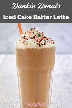 an iced cake batter latte with whipped cream and sprinkles on top