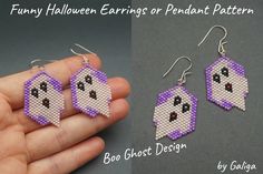 a pair of earrings that have been made to look like ghost beads and are being held in someone's hand