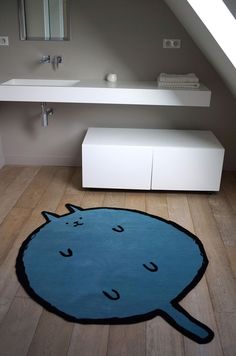 a bathroom with a blue rug on the floor